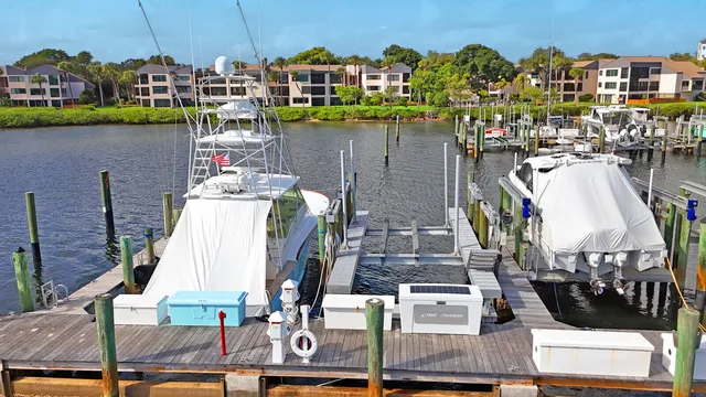 a view of a lake with boats and trees in the back