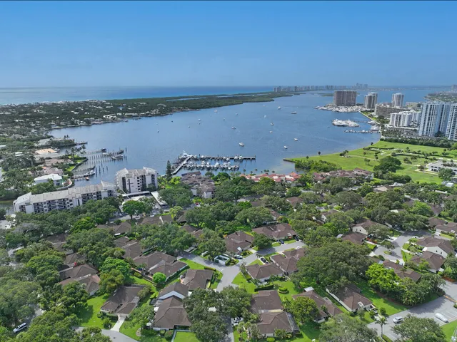 an aerial view of a house with a yard and lake view