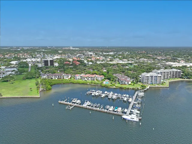 an aerial view of a house with a table chairs and a lake view