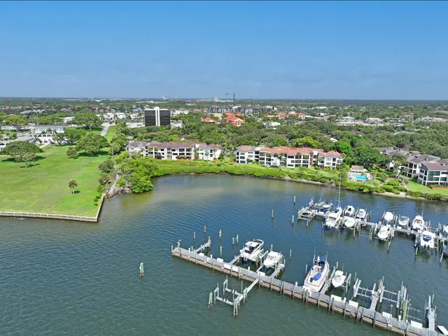 an aerial view of a house with a yard and lake view