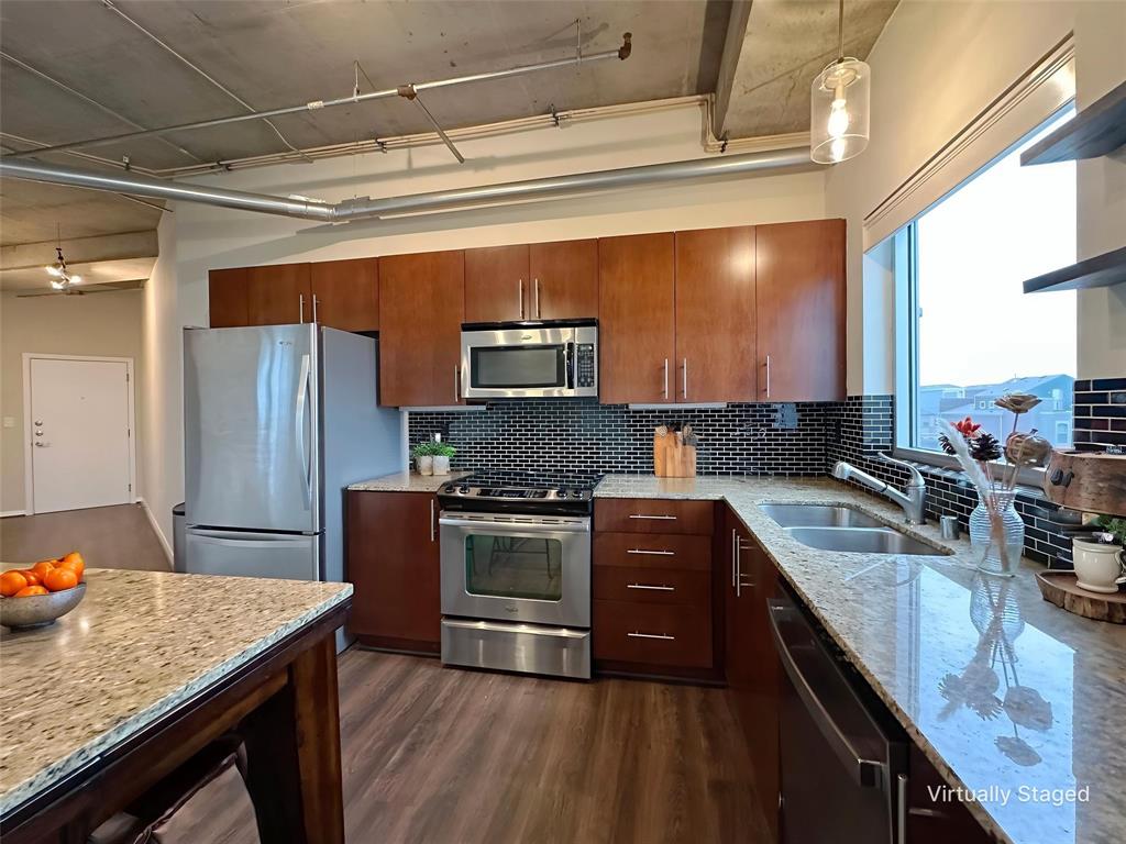 1001 Belleview Street, Unit 307 Dallas, TX 75215 - Photo 12 of 40 a kitchen with stainless steel appliances granite countertop a sink stove and refrigerator