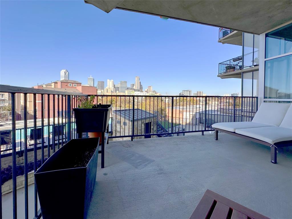 1001 Belleview Street, Unit 307 Dallas, TX 75215 - Photo 15 of 40 a view of a balcony with chair and a barbeque