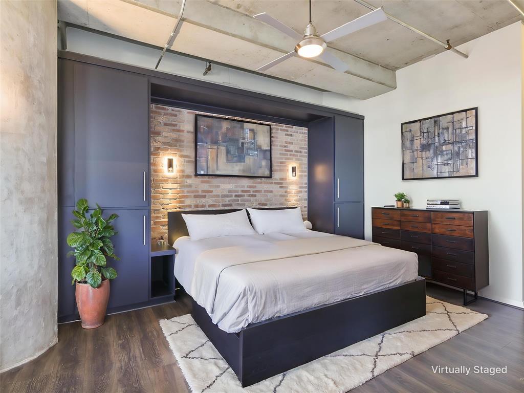 1001 Belleview Street, Unit 307 Dallas, TX 75215 - Photo 17 of 40 a bedroom with a large bed and a potted plant