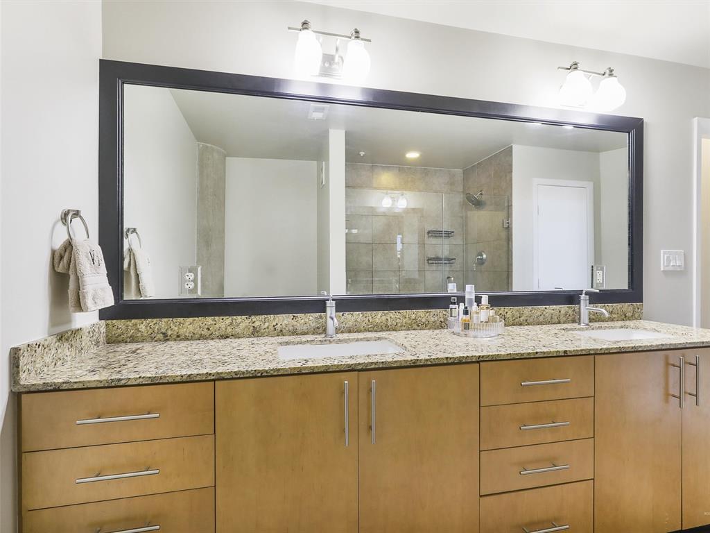 1001 Belleview Street, Unit 307 Dallas, TX 75215 - Photo 19 of 40 a bathroom with a granite countertop sink and a mirror