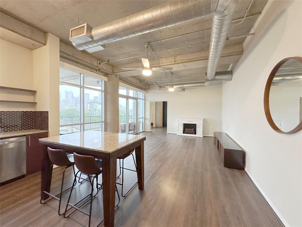 1001 Belleview Street, Unit 307 Dallas, TX 75215 - Photo 21 of 40 a view of a dining room with furniture window and wooden floor