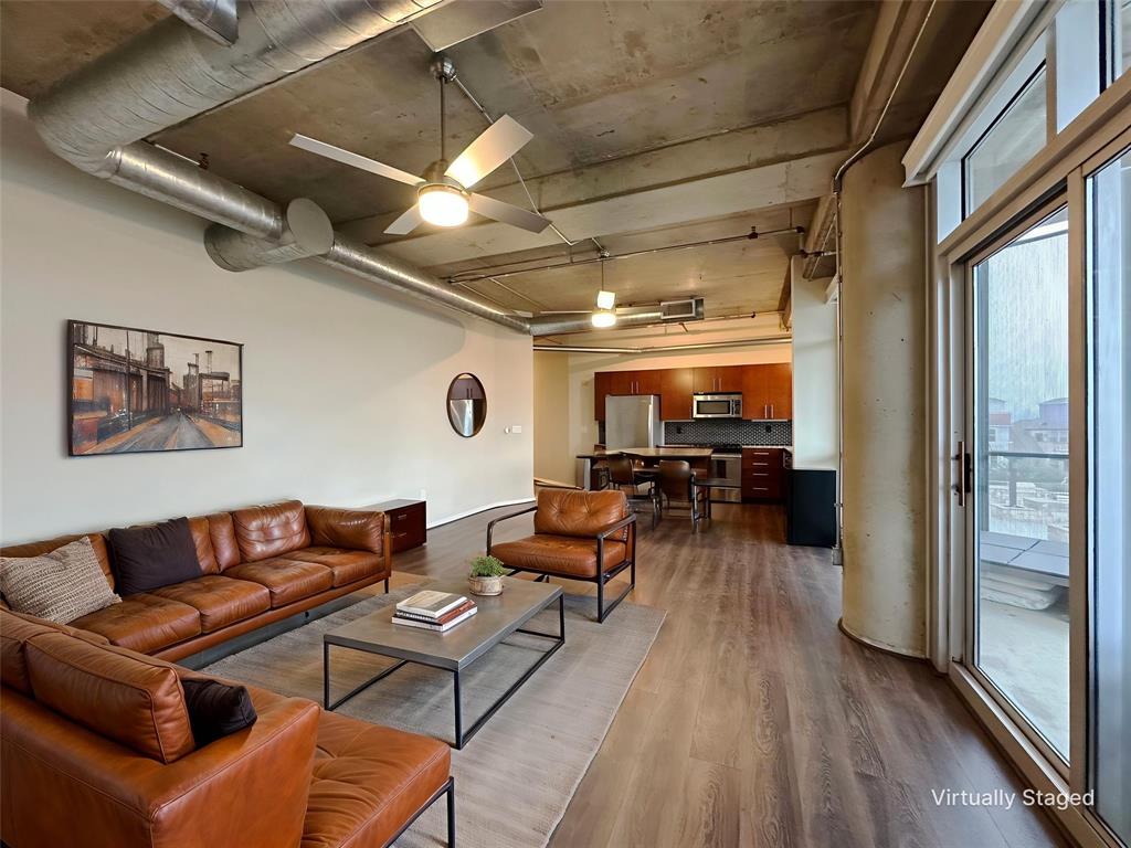 1001 Belleview Street, Unit 307 Dallas, TX 75215 - Photo 24 of 40 a living room with furniture and a wooden floor