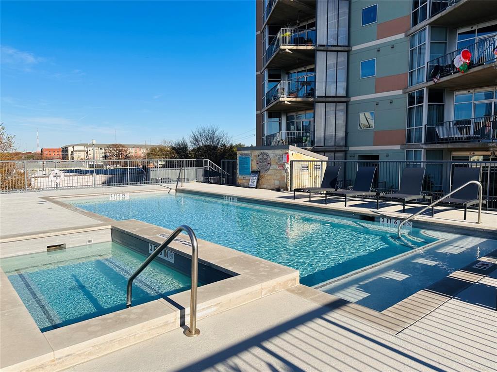 1001 Belleview Street, Unit 307 Dallas, TX 75215 - Photo 36 of 40 a view of a swimming pool with a lounge chairs