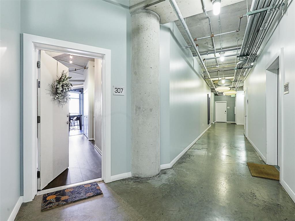 1001 Belleview Street, Unit 307 Dallas, TX 75215 - Photo 6 of 40 a view of a hallway with wooden floor