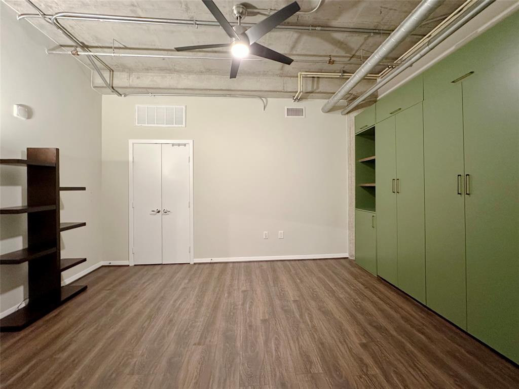 1001 Belleview Street, Unit 307 Dallas, TX 75215 - Photo 10 of 40 a view of an empty room with wooden floor and a window