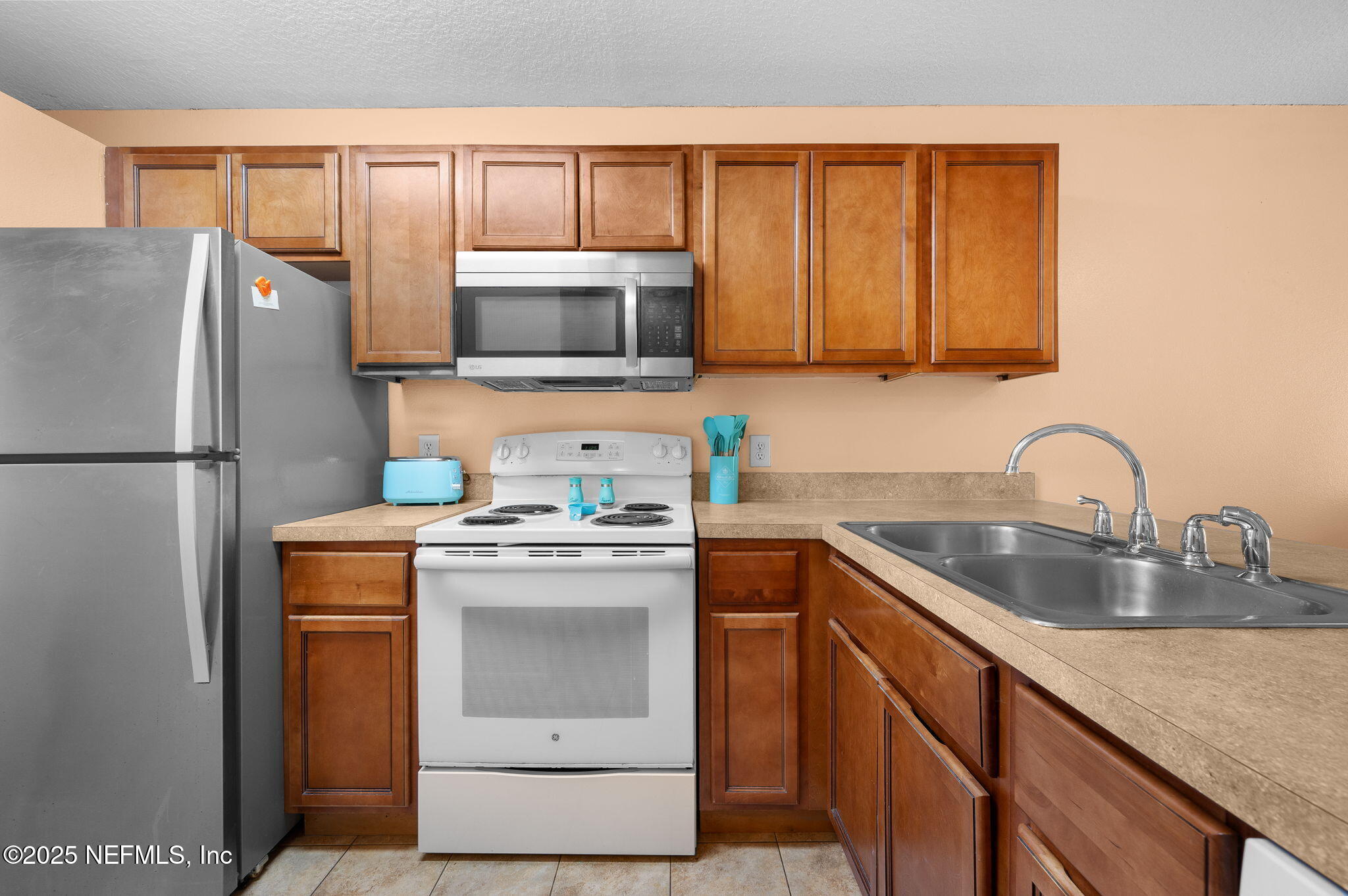 700 West Pope Road, Unit M103 St. Augustine, FL 32080 - Photo 12 of 30 a kitchen with appliances a sink and lots of cabinets