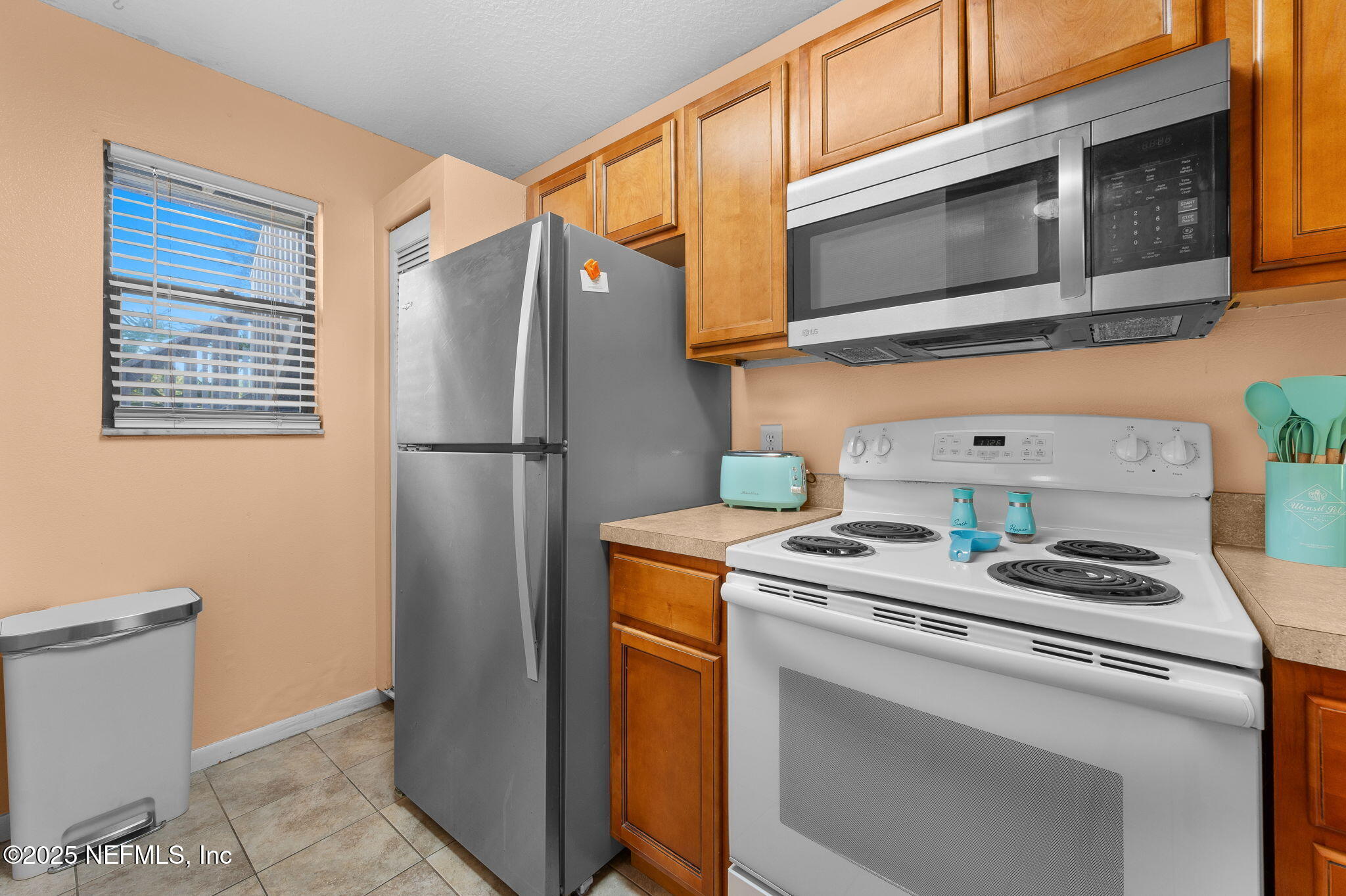 700 West Pope Road, Unit M103 St. Augustine, FL 32080 - Photo 14 of 30 a kitchen with stainless steel appliances granite countertop a refrigerator and a stove top oven