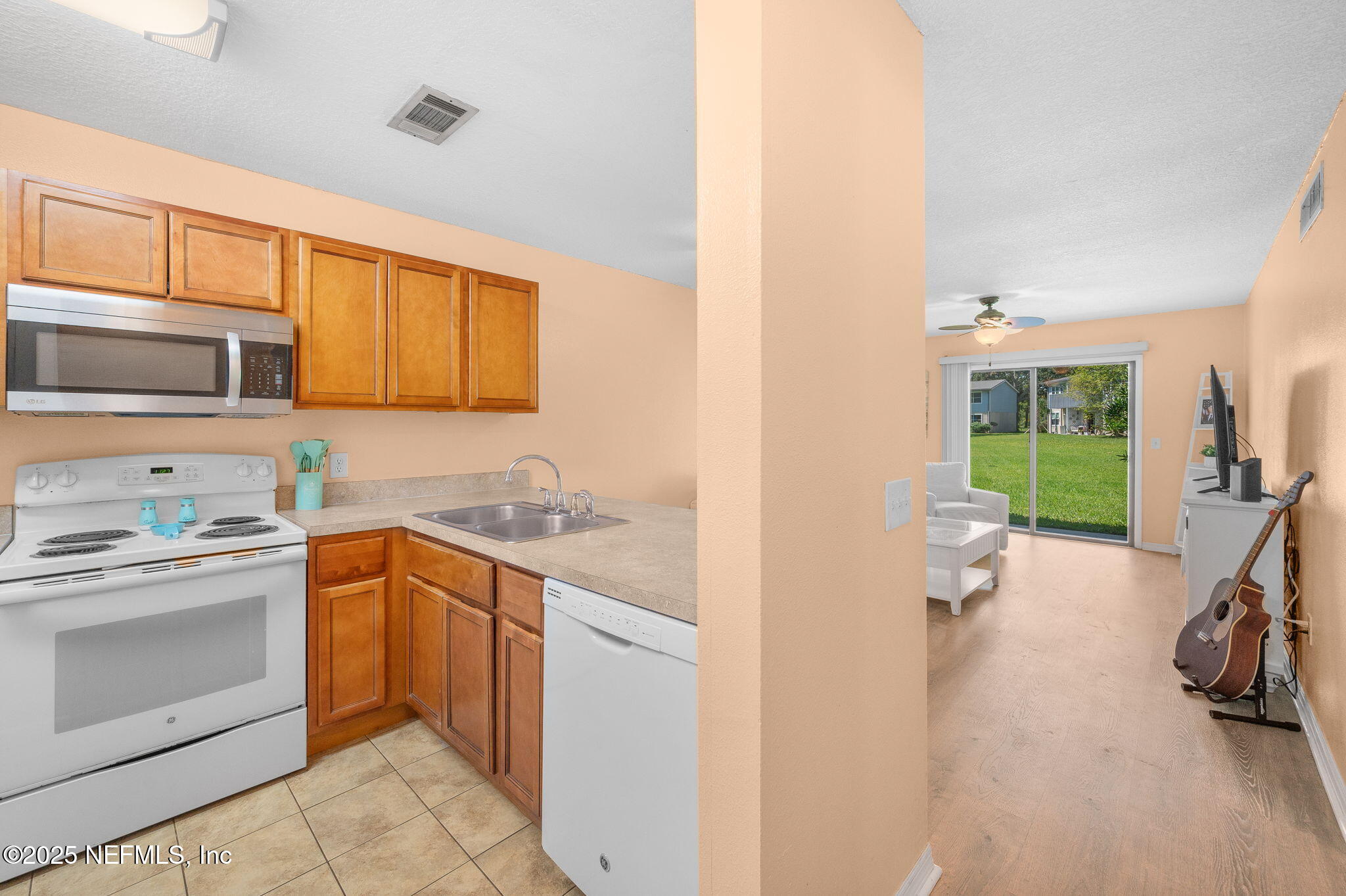 700 West Pope Road, Unit M103 St. Augustine, FL 32080 - Photo 15 of 30 a kitchen with a sink stove and cabinets