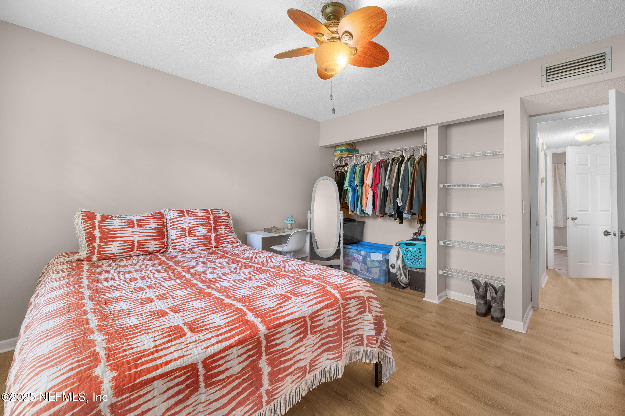 700 West Pope Road, Unit M103 St. Augustine, FL 32080 - Photo 16 of 30 a bedroom with a bed and a chandelier