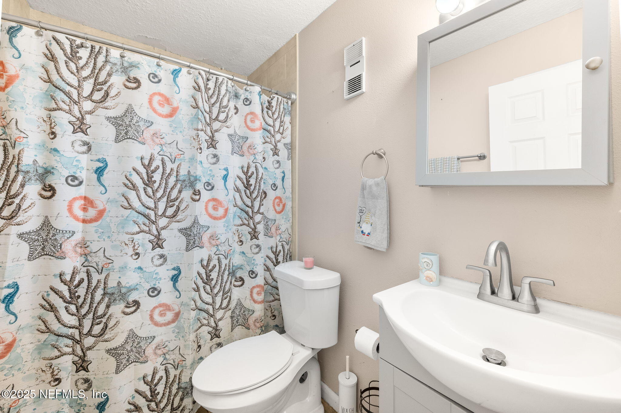 700 West Pope Road, Unit M103 St. Augustine, FL 32080 - Photo 18 of 30 a bathroom with a sink and mirror with toilet
