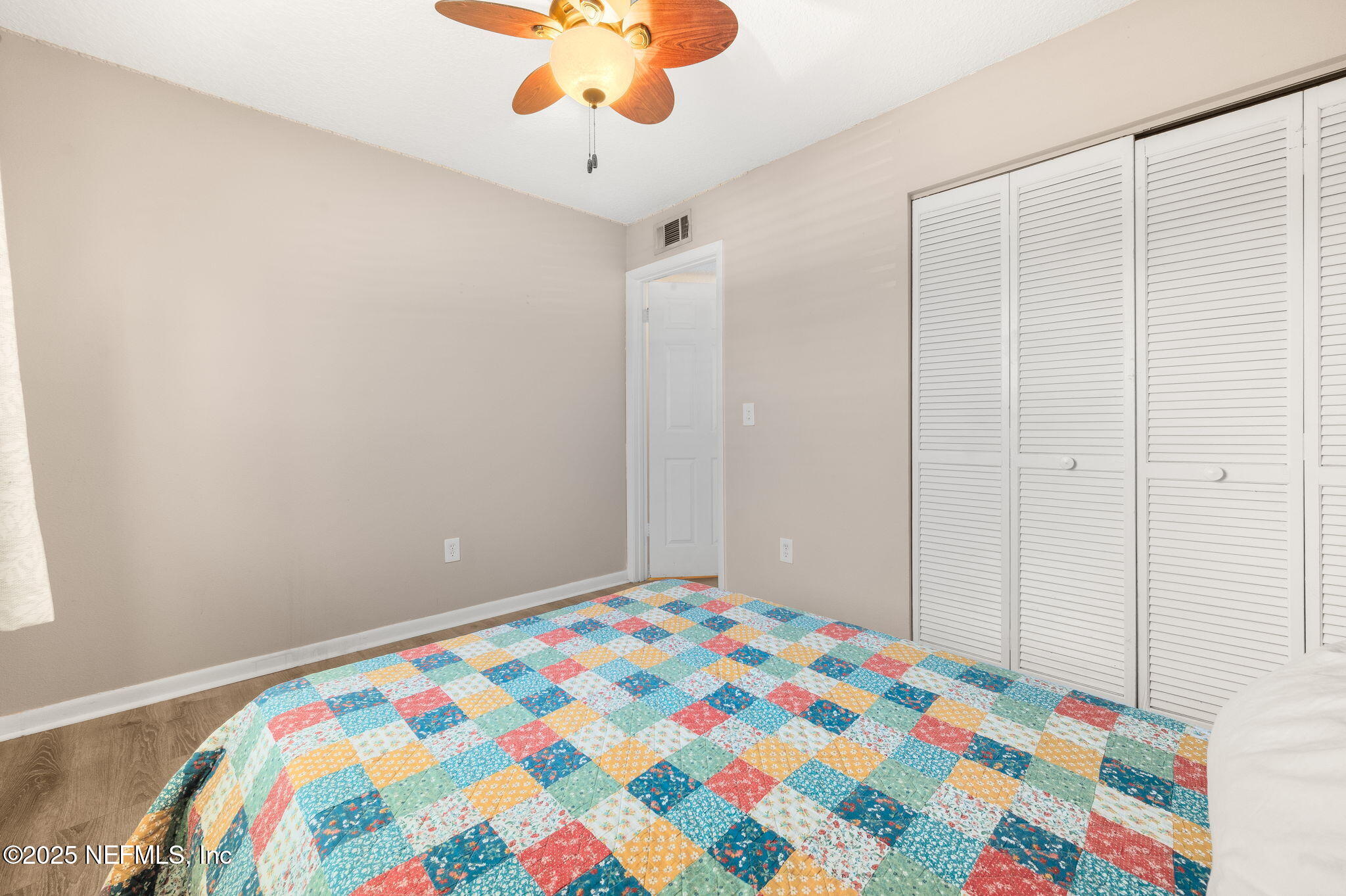 700 West Pope Road, Unit M103 St. Augustine, FL 32080 - Photo 20 of 30 a bedroom with a bed and a chandelier