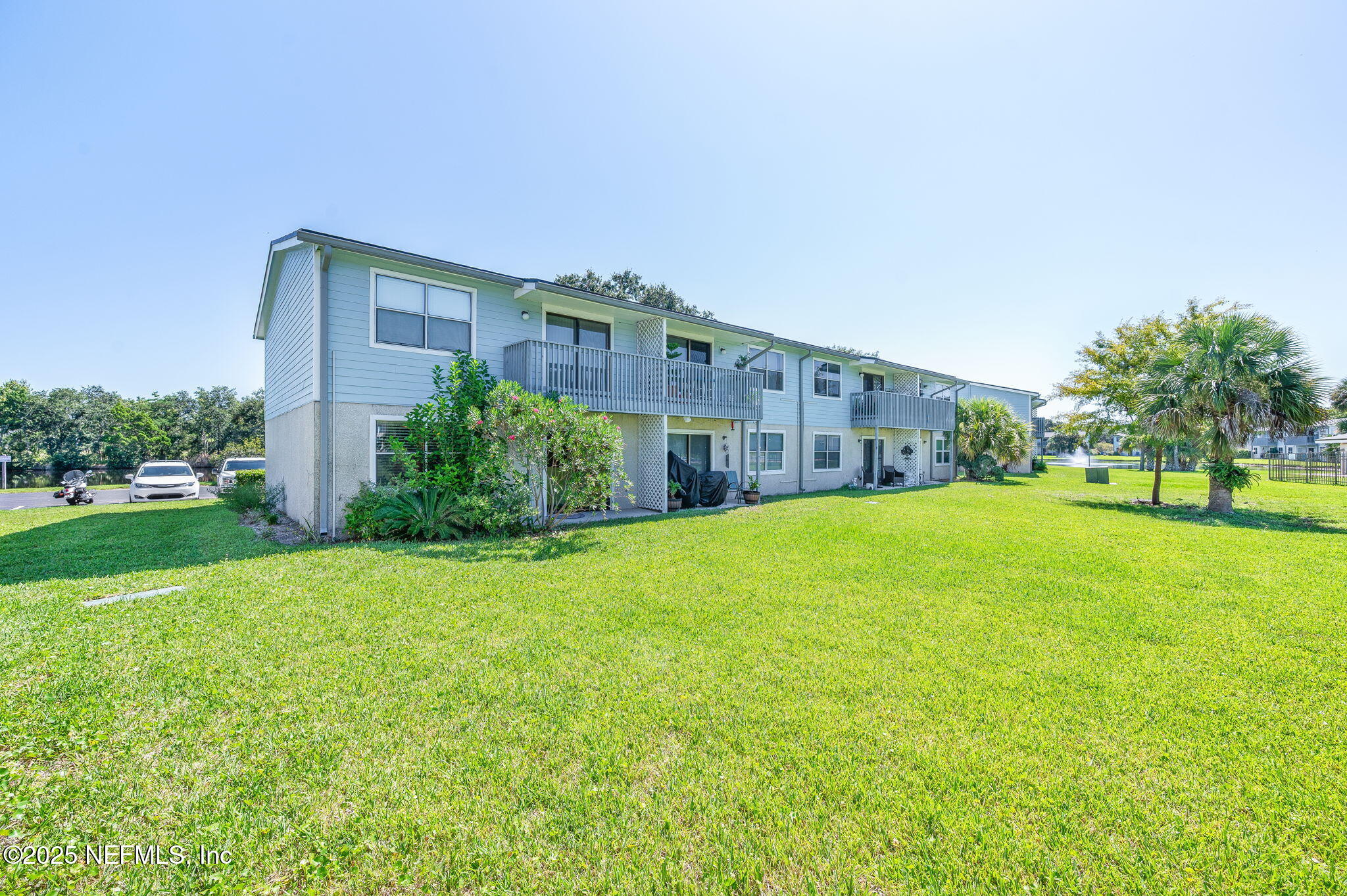 700 West Pope Road, Unit M103 St. Augustine, FL 32080 - Photo 23 of 30 a view of a house with a big yard potted plants and large tree
