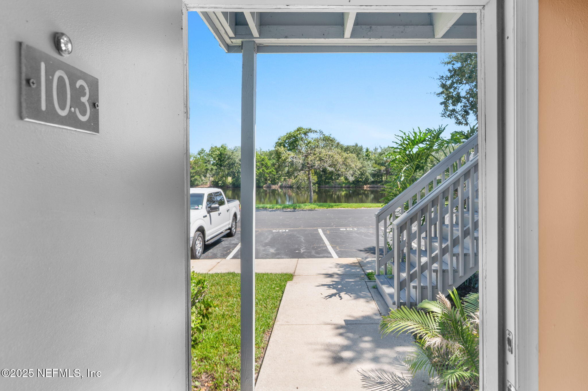 700 West Pope Road, Unit M103 St. Augustine, FL 32080 - Photo 4 of 30 a path view of a house with a yard and potted plants