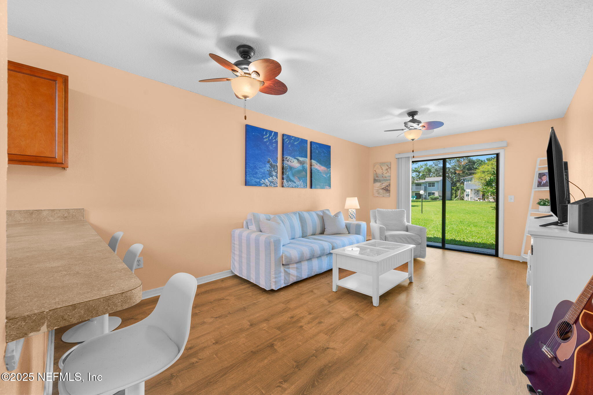 700 West Pope Road, Unit M103 St. Augustine, FL 32080 - Photo 5 of 30 a living room with furniture and a floor to ceiling window