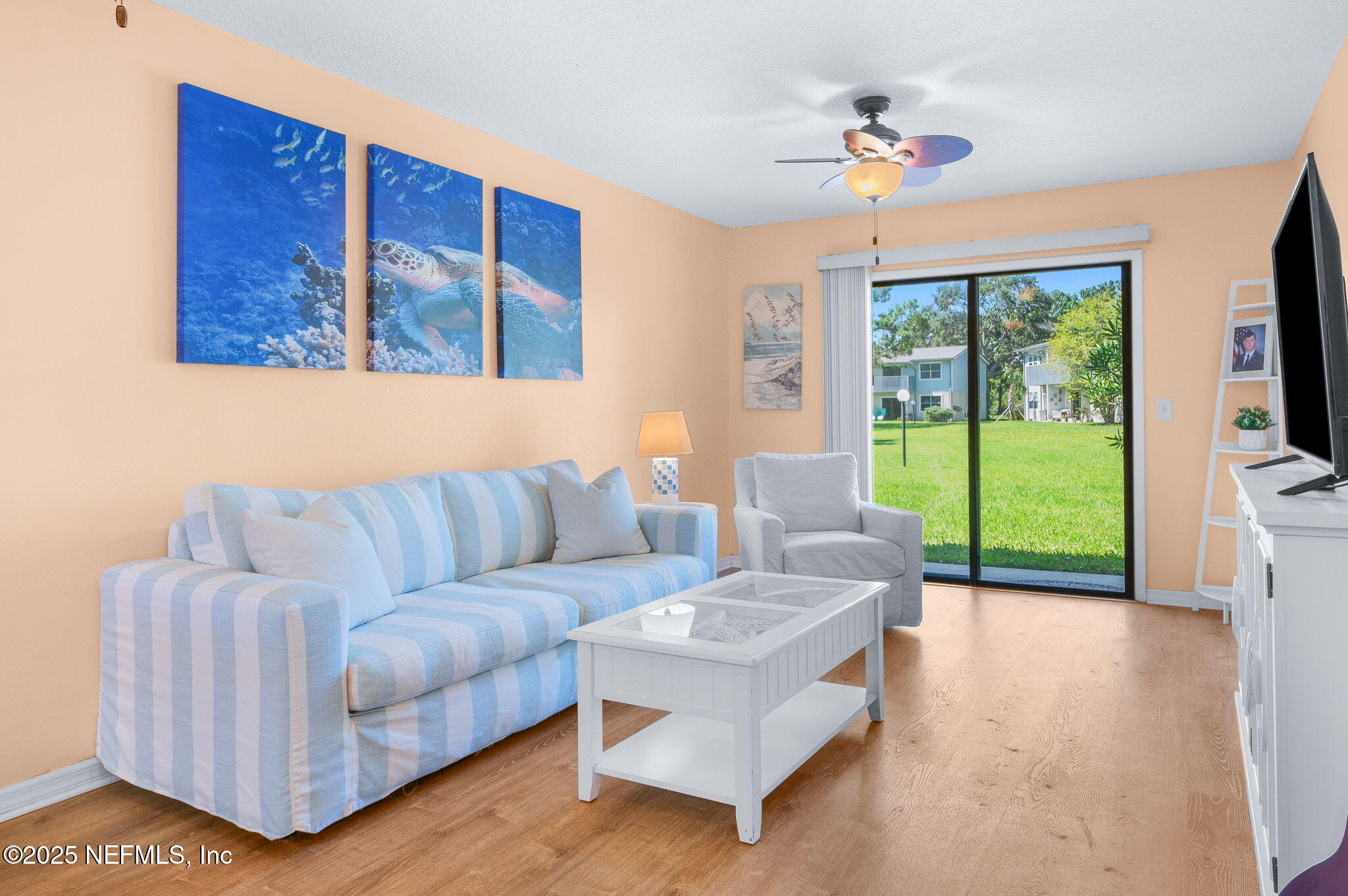 700 West Pope Road, Unit M103 St. Augustine, FL 32080 - Photo 8 of 30 a living room with furniture and a flat screen tv