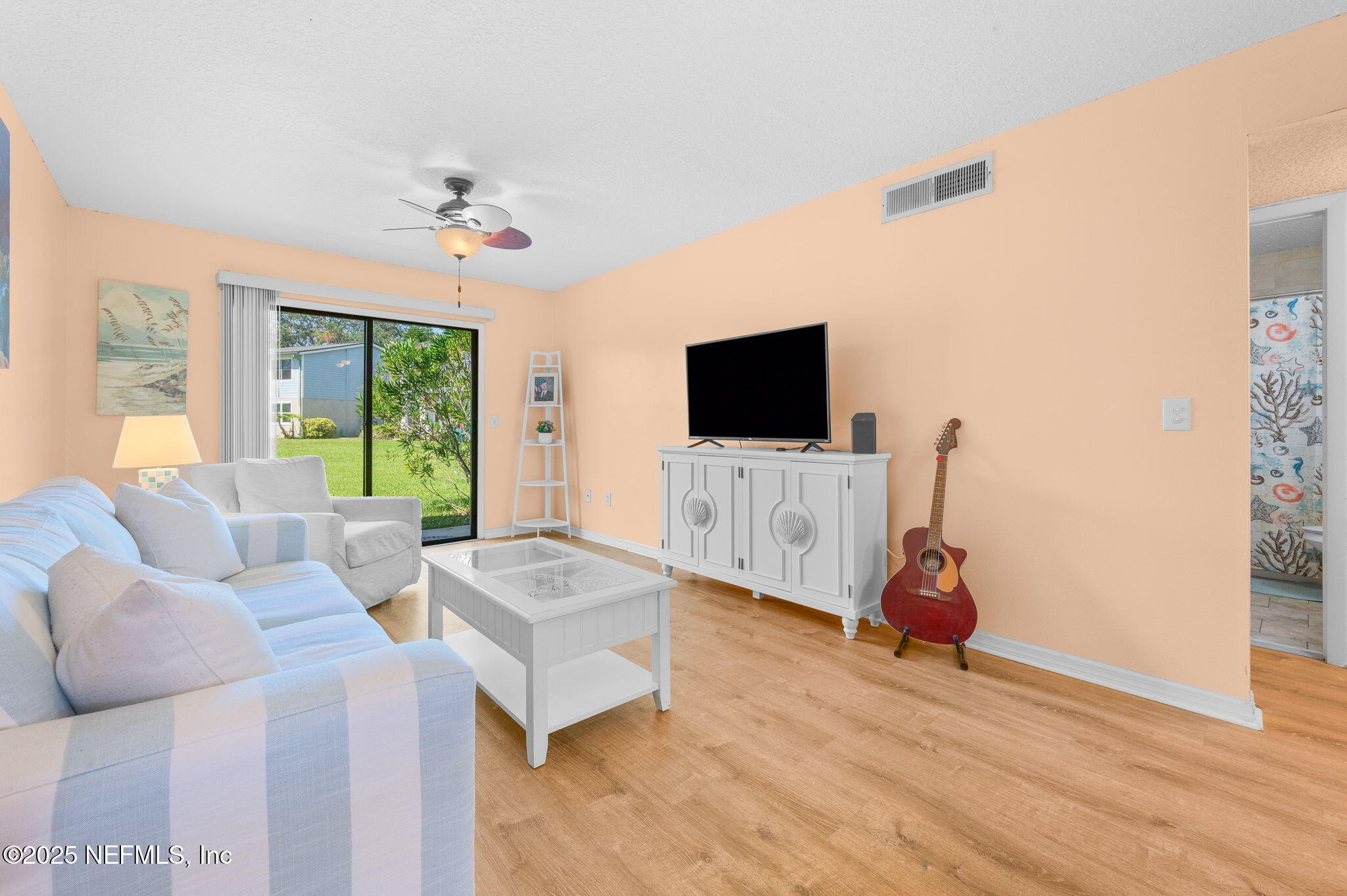 700 West Pope Road, Unit M103 St. Augustine, FL 32080 - Photo 9 of 30 a living room with furniture and a flat screen tv