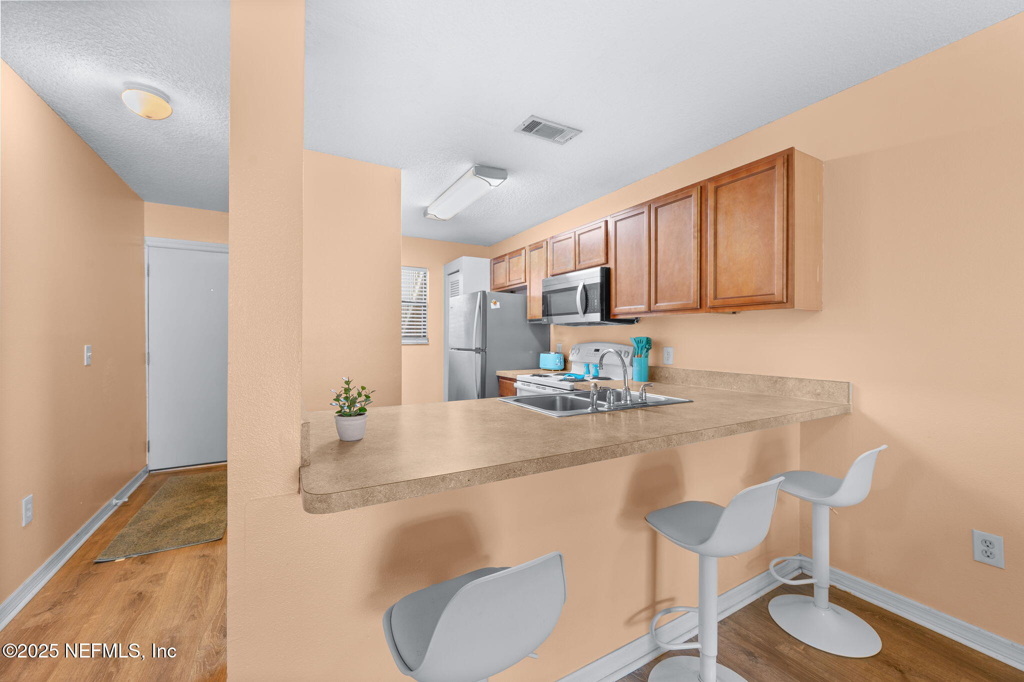 700 West Pope Road, Unit M103 St. Augustine, FL 32080 - Photo 10 of 30 a kitchen with kitchen island a stove a table and chairs in it