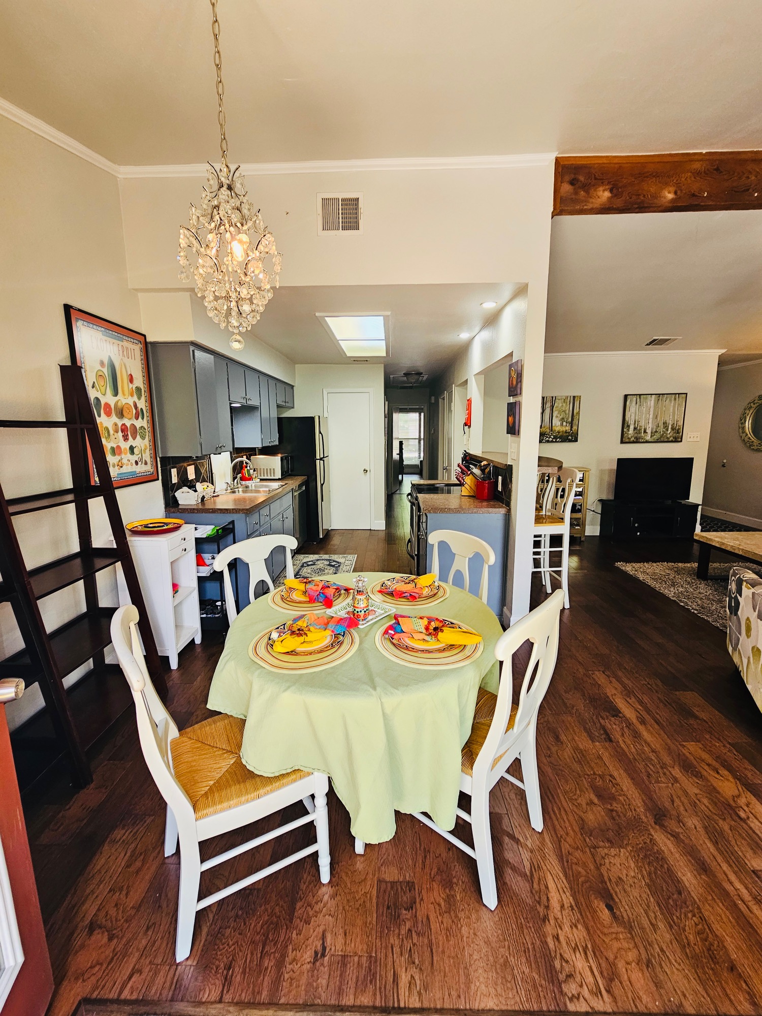 5107 Leralynn Street, Unit 304 Austin, TX 78751 - Photo 6 of 28 Dining area with dark wood-style floors and a notable chandelier