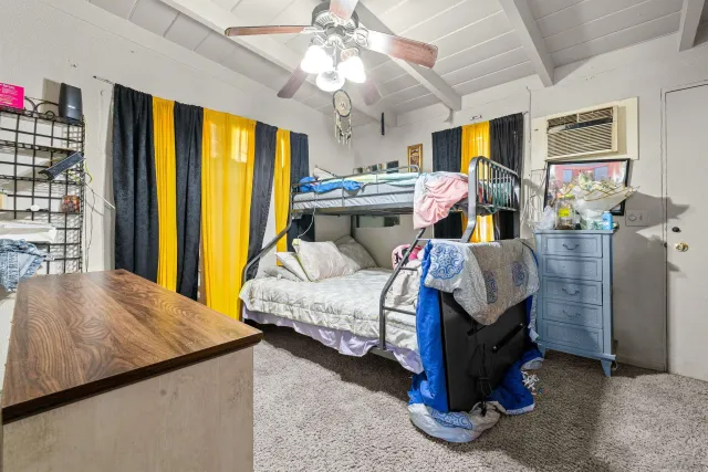 a bedroom with bed and window