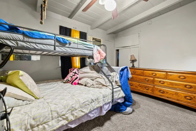 a bed room with a bed and a chair