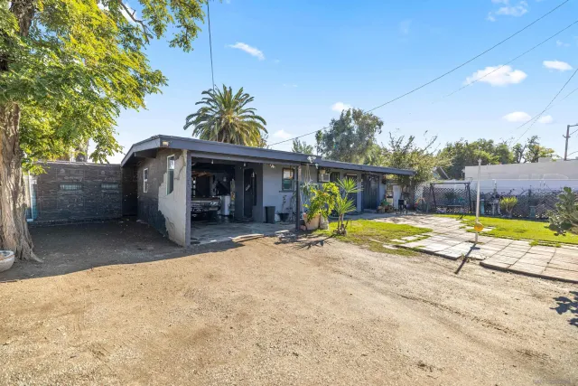 a view of a house with swimming pool and a porch with a sitting area
