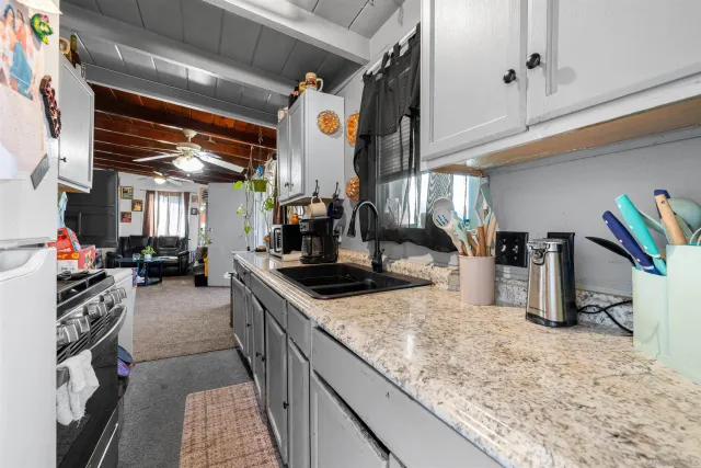 a kitchen with stainless steel appliances granite countertop a sink and a stove