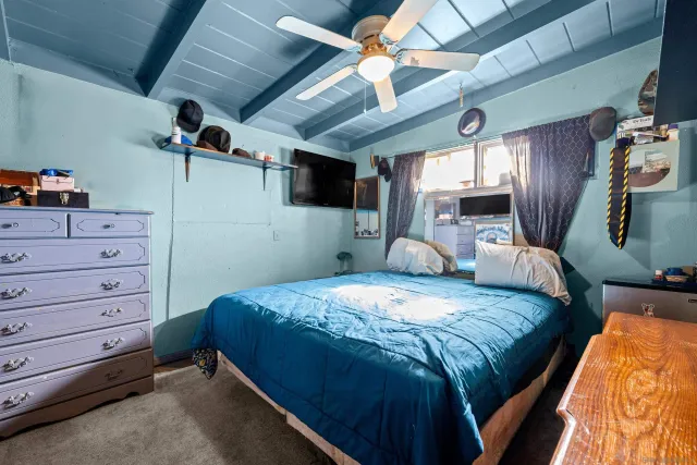 a bed sitting in a bedroom and dresser