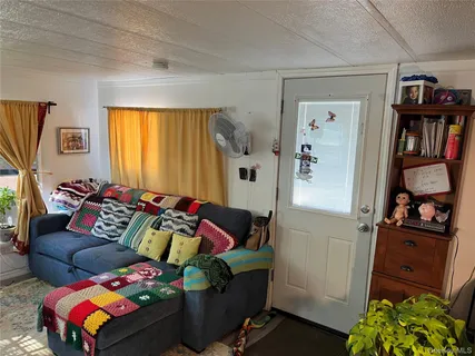 a living room with furniture and a book shelf