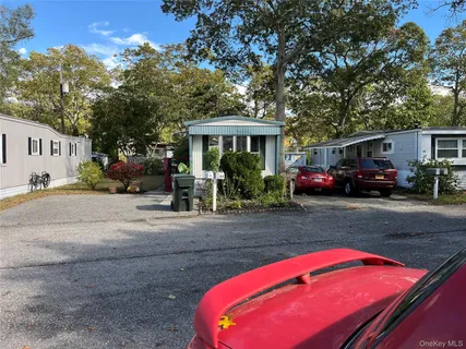a front view of a house with cars parked