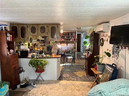 a living room filled with furniture and a flat screen tv