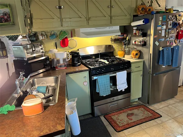 a stove top oven sitting inside of a kitchen