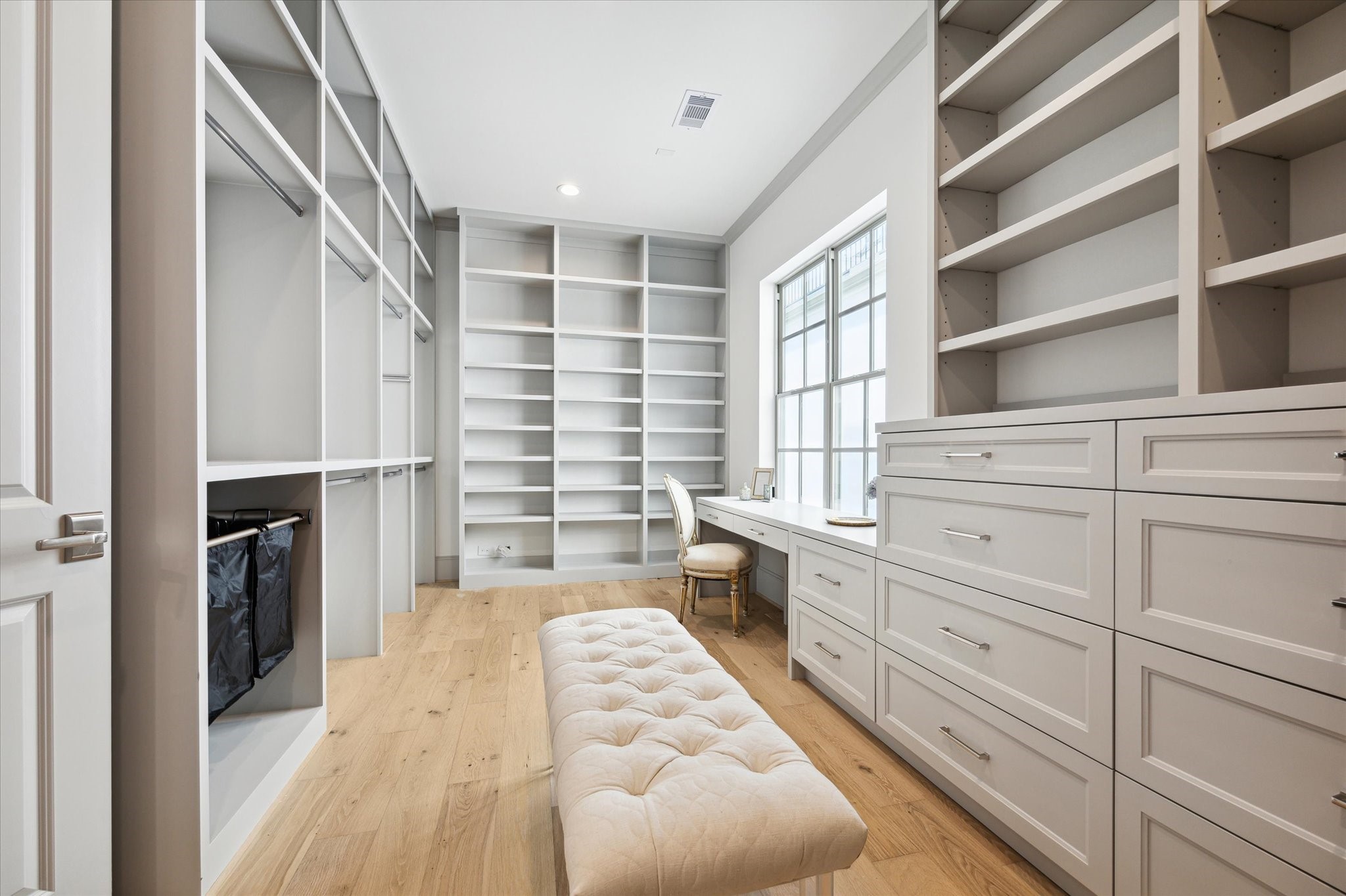 207 Sutton Row Place Houston, TX 77024 - Photo 17 of 29 Upgraded custom Her closet with abundant handing space, banks of drawers and shelving, complete with vanity at window.
