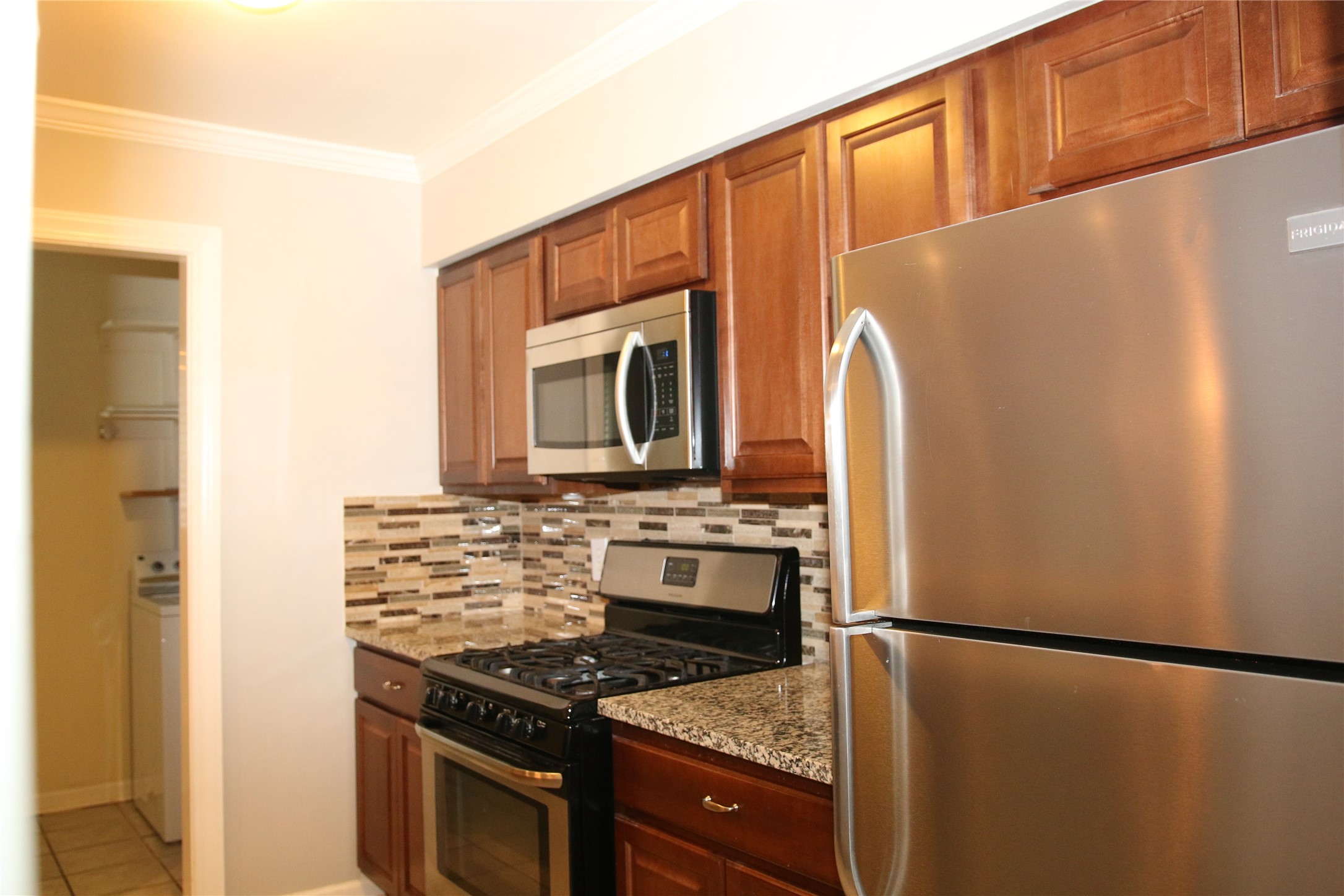 700 Castle Ridge Road, Unit A Austin, TX 78746 - Photo 12 of 34 a kitchen with stainless steel appliances granite countertop a refrigerator and a stove