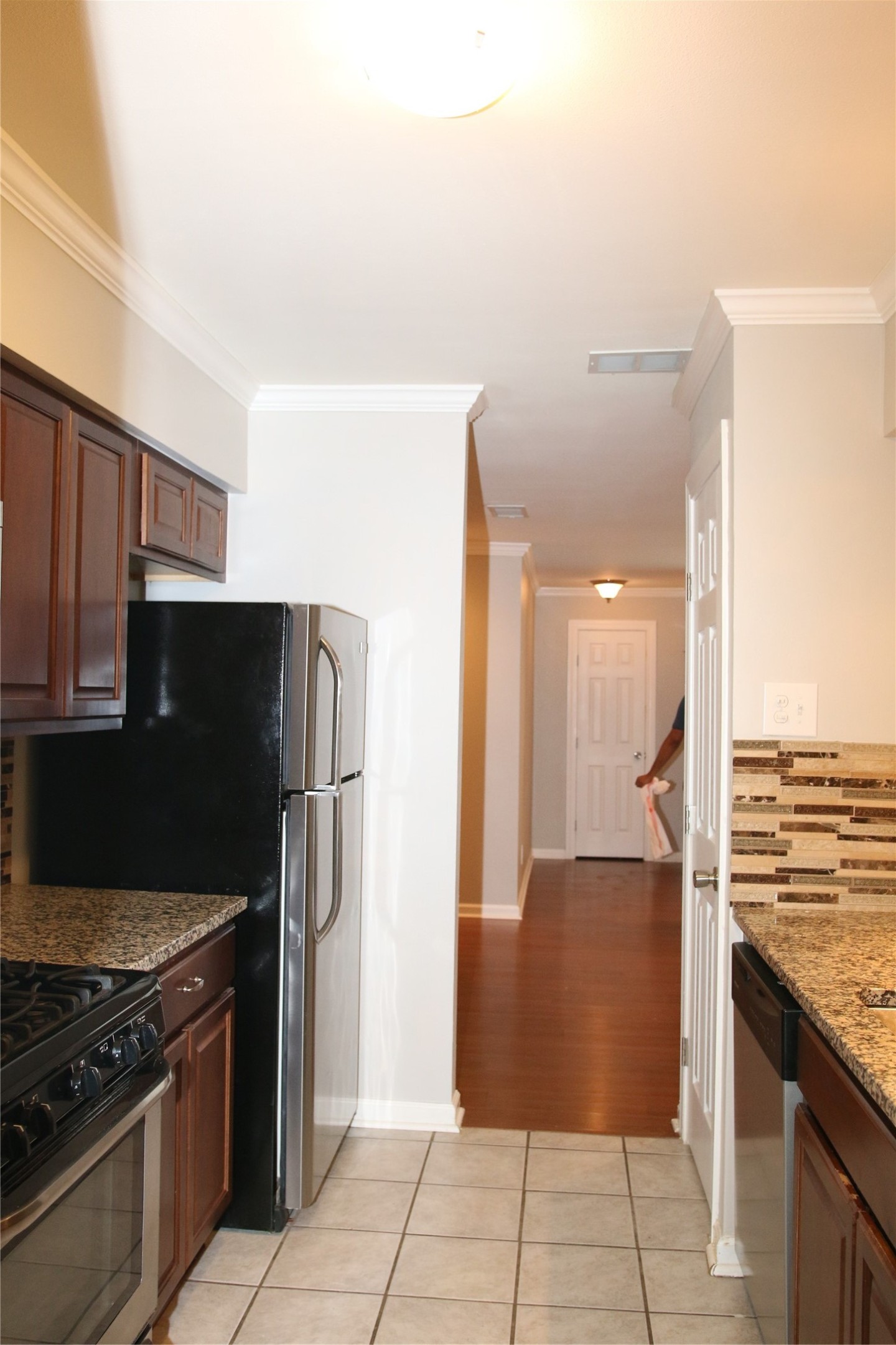 700 Castle Ridge Road, Unit A Austin, TX 78746 - Photo 13 of 34 a kitchen with stainless steel appliances granite countertop a refrigerator and a stove top oven