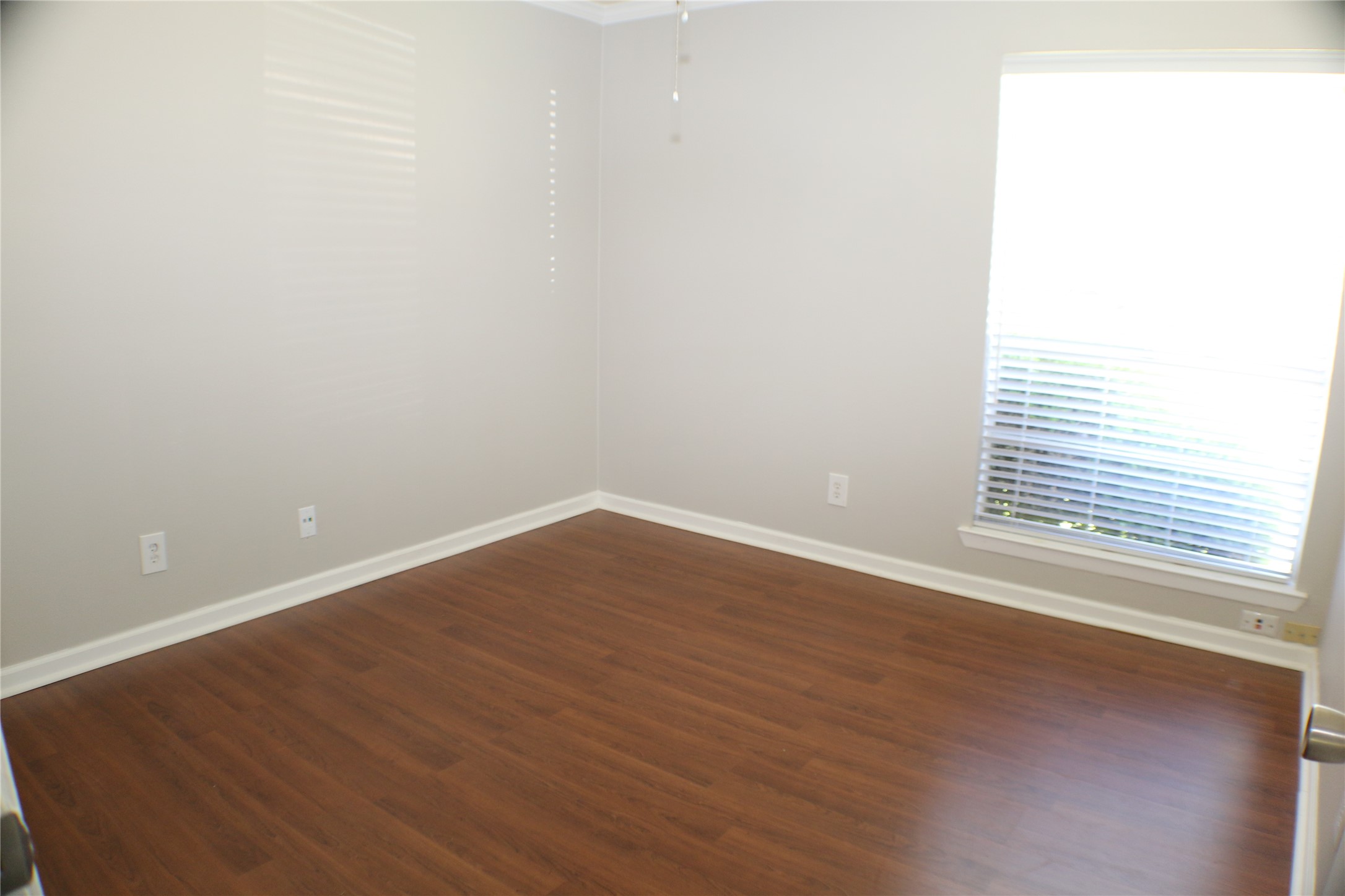 700 Castle Ridge Road, Unit A Austin, TX 78746 - Photo 23 of 34 a view of an empty room with wooden floor and a window