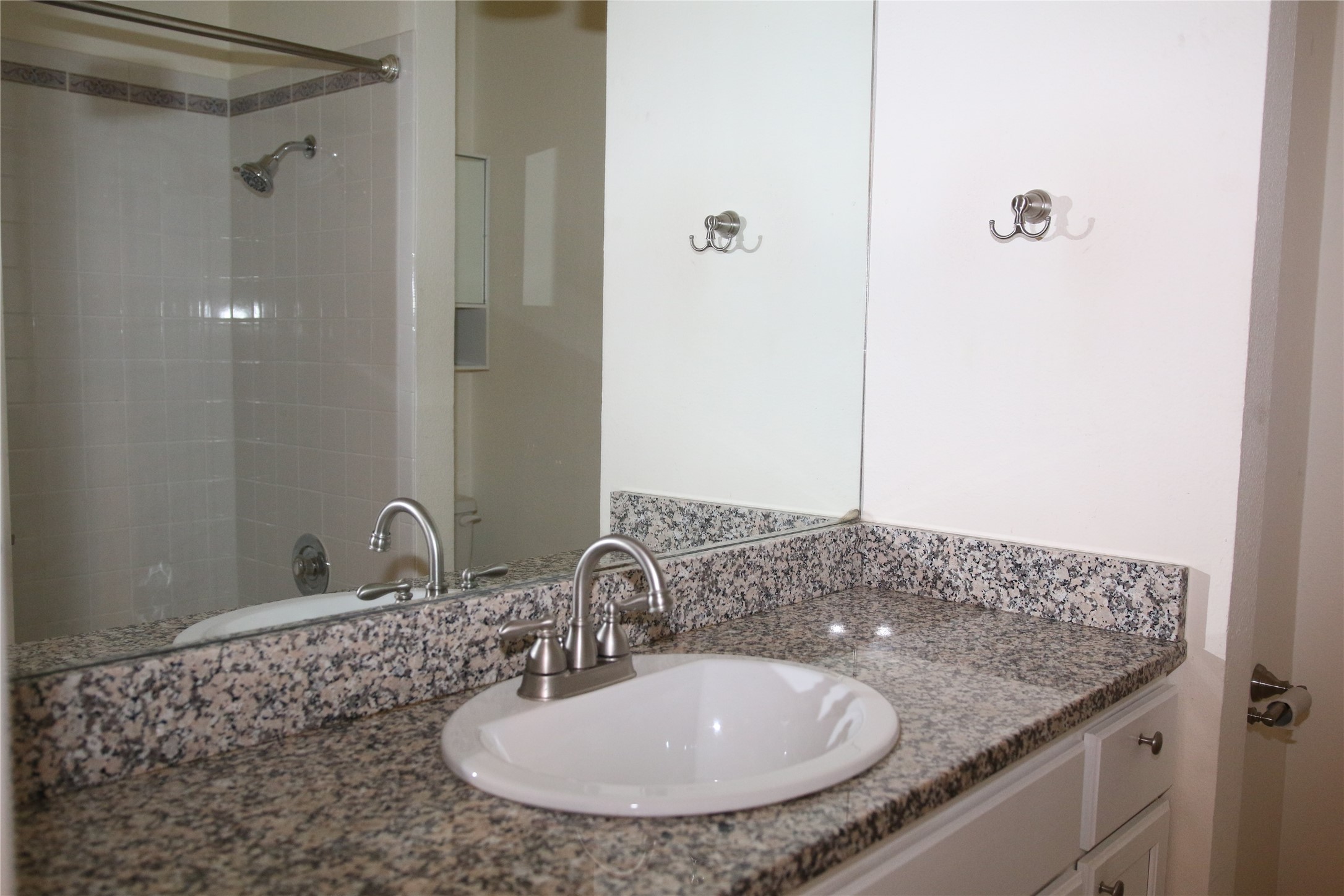 700 Castle Ridge Road, Unit A Austin, TX 78746 - Photo 29 of 34 a bathroom with a granite countertop sink a mirror and shower