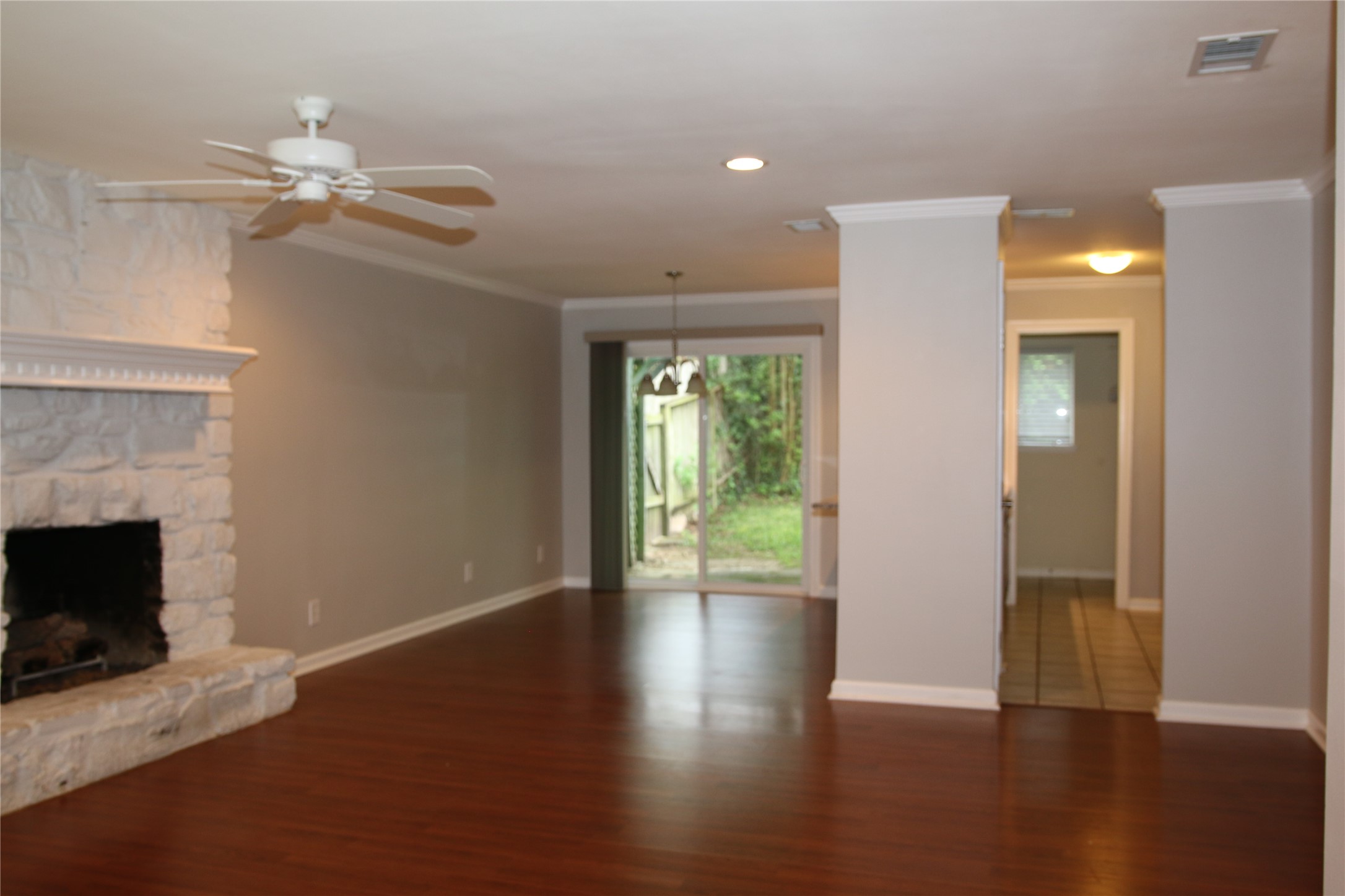700 Castle Ridge Road, Unit A Austin, TX 78746 - Photo 5 of 34 a view of an empty room with wooden floor and a fireplace