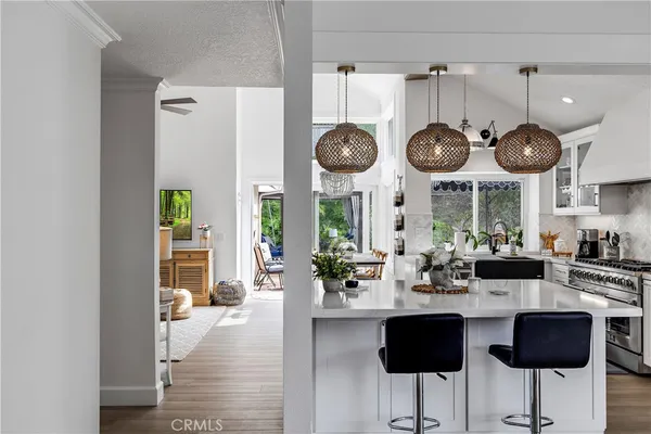 a kitchen with a sink a table and chairs in it