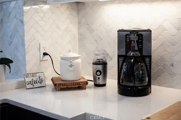 a bed sitting in a bedroom next to a lamp
