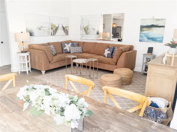 a view of a patio with table and chairs under an umbrella with a barbeque grill and plants