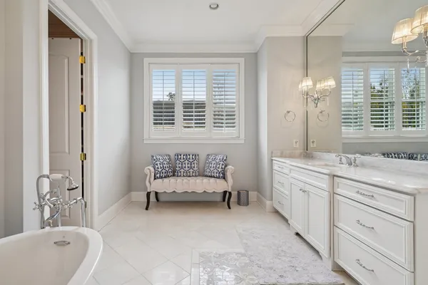 a front view of a house with a yard and potted plants