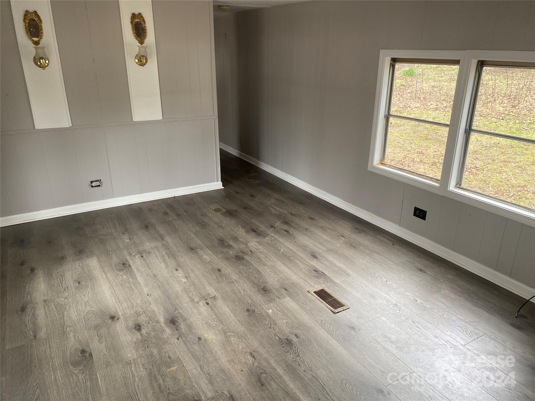 116 Lowman Street, Unit 6 Rutherford College, NC 28690 - Photo 2 of 7 an empty room with wooden floor and windows