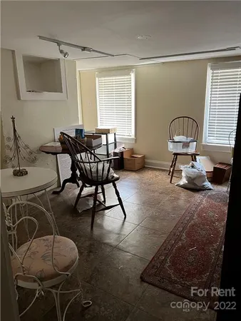 a living room with furniture a window and a table