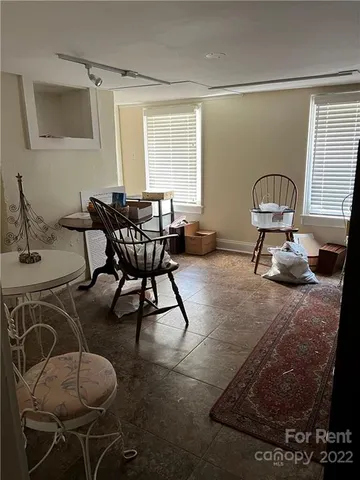 a living room with furniture a window and a table