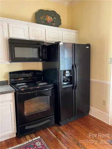 a kitchen with stainless steel appliances granite countertop a refrigerator and a stove