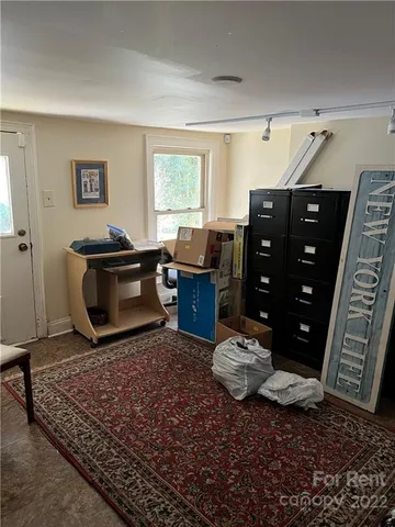 a living room with hard wood floor and a fireplace